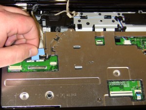 Loosen the LCD display cable from motherboard the by pulling up on the tab. 