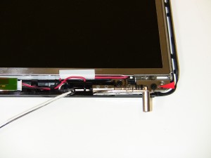 Unscrew (1) 2.5mm x 5mm screws holding the left LCD rail to the base.  