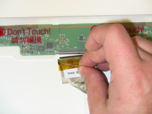 Remove the LCD Cable by flipping the screen over, on a clean surface so it doesn’t get scratched, and remove the securing tape and disconnect the cable from the connector. 