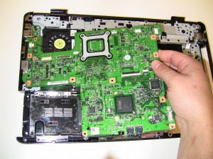 The motherboard part number is located on the front of the motherboard under the touchpad palm rest. 