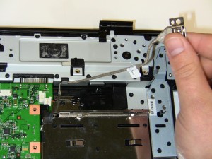 Unscrew the (2) 2.5mm x 5mm 1545 USB port screws  and disconnect the cable from the motherboard. 