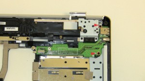 Remove the (2) 2.5mm x 5mm screws that hold the S-Video Out / USB / SIM Right-Side IO Circuit Board on the Base assembly.