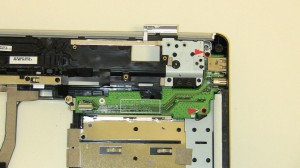 Remove the (2) 2.5mm x 5mm screws that hold the 1525/1526 S-Video Out / USB / SIM Right-Side IO Circuit Board on the Base assembly.