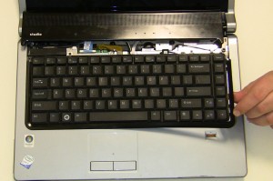 Remove the Keyboard Trim Plastic. Start by lifting the plastic at the top corner and working your way around the keyboard. 