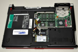 On the bottom of the laptop, loosen the wireless antenna cables and unscrew the 2.5mm x 5mm left and right hinge screws. 