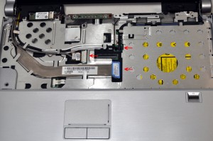 Disconnect the Camera cable, the LCD Display cable, and pull the wireless antenna cables through the motherboard. 