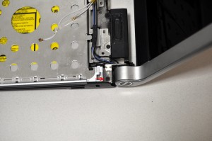 Unscrew the 2.5mm x 5mm left hinge screw. 