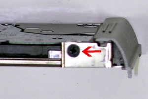 Remove the 3mm x 3mm hard drive caddy screw and remove the caddy. 