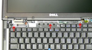 Carefully lift the keyboard and turn it over to reveal the keyboard cable.