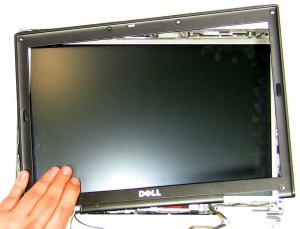 Starting at the bottom of the LCD screen, lift the bezel until it unsnaps and work your way around the edge of the screen