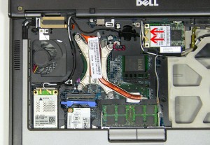 Press the clips, on the left and right side of the WLAN card, forward until the card pivots up. 