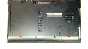 Slide the Bottom Base Cover down and lift it off of the laptop.