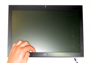 Carefully remove the LCD Bezel by unsnapping it around the edge of the screen.