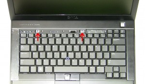Using the tab at the top of the keyboard, slide the keyboard up and lift the keyboard away from the laptop. 