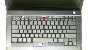 Using the tab at the top of the keyboard, slide the keyboard up and lift the Keyboard away from the laptop. 