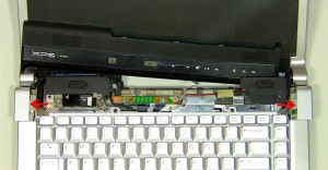 Lift the hinge covers off of the laptop.