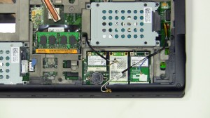 Loosen the antenna cables from the routing on the bottom of the laptop.