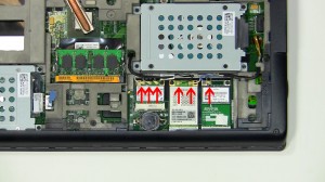 Loosen the antenna cables from the routing on the bottom of the laptop.