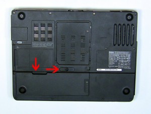 On the bottom of the laptop, slide the battery latch to the right and lift the battery out. 