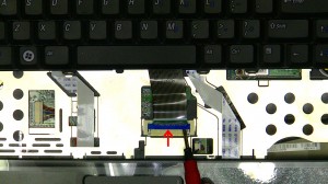 Carefully lift the keyboard up and position it above the power button. 