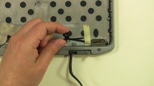 Remove the plastic cover above the right side hinge.