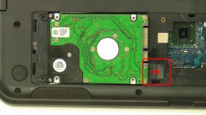 Lift and slide the hard drive out of the laptop using the tab.