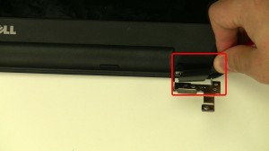 Use a screwdriver to pry the hinge covers off of the display.