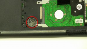 Press the edge of the CMOS battery over and it will pop out of the slot.