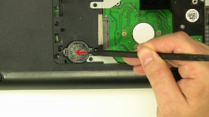 Press the edge of the CMOS battery over and it will pop out of the slot.