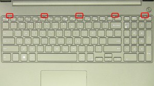 Using a small flat head screwdriver, press in the keyboard latches and carefully remove and turn over the keyboard.