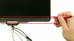 Using a flat head screwdriver, carefully unsnap the bottom LCD bezel.