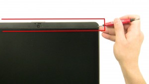 Using a flat head screwdriver, carefully unsnap the top & bottom LCD bezels.