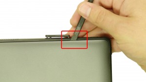 Using a scribe, carefully pry up and unsnap the bottom cover access door.