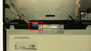 Flip over LCD display, remove blue protective strip and peel back tape from LCD cable.
