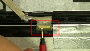Gently pull back metal fastener holding in LCD cable.