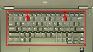 Using a plastic scribe or small flat head screwdriver, carefully pry up the Keyboard Bezel & remove it from the laptop.