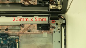 Remove the 1 - M2.5 x 5mm right hinge screw.