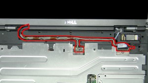 Pull the antenna cables through the laptop base.