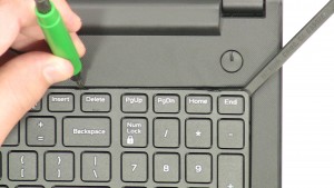 Press in the keyboard latches and loosen the keyboard. 