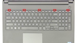 Press in the keyboard latches and loosen the keyboard. 