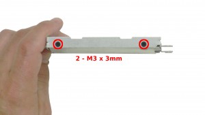 Remove the 4 - M3 x 3mm caddy screws on both sides of the hard drive.