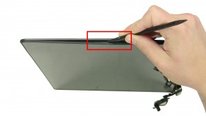 Using a plastic scribe, unsnap the back cover around the edges of the screen.