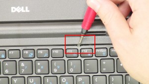 Using a small flat head screwdriver, carefully pry up and unsnap the Keyboard Bezel.