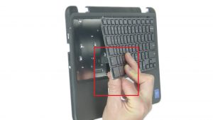 Use plastic scribe to separate keyboard from the release hole labeled 