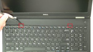 Use plastic scribe to separate and remove Keyboard Bezel.