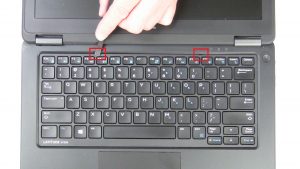 Use plastic scribe to separate and remove Keyboard Bezel.