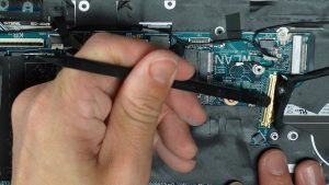 Disconnect the motherboard using a plastic scribe to unclip and disconnect the cables.