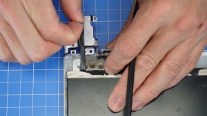 Carefully pull adhesive strips under the LCD screen downward until they are completely removed.