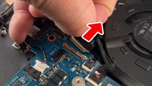 Unclip the locking tab and disconnect the I/O board cable.