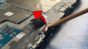 Peel back the adhesive tape to expose the I/O board cable.
